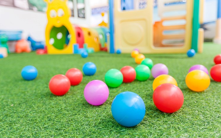 Colorful playground balls on green artificial turf surface in Montgomery, TX