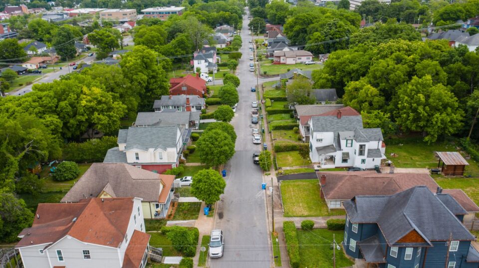 Aerial view of an established, tree-shaded residential neighborhood, typical of West University Place, TX