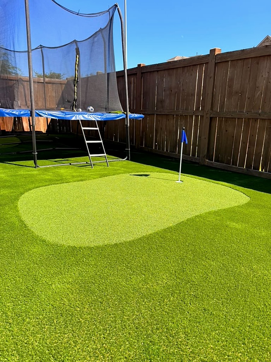 Backyard putting green with a flag on artificial turf in Spring, TX