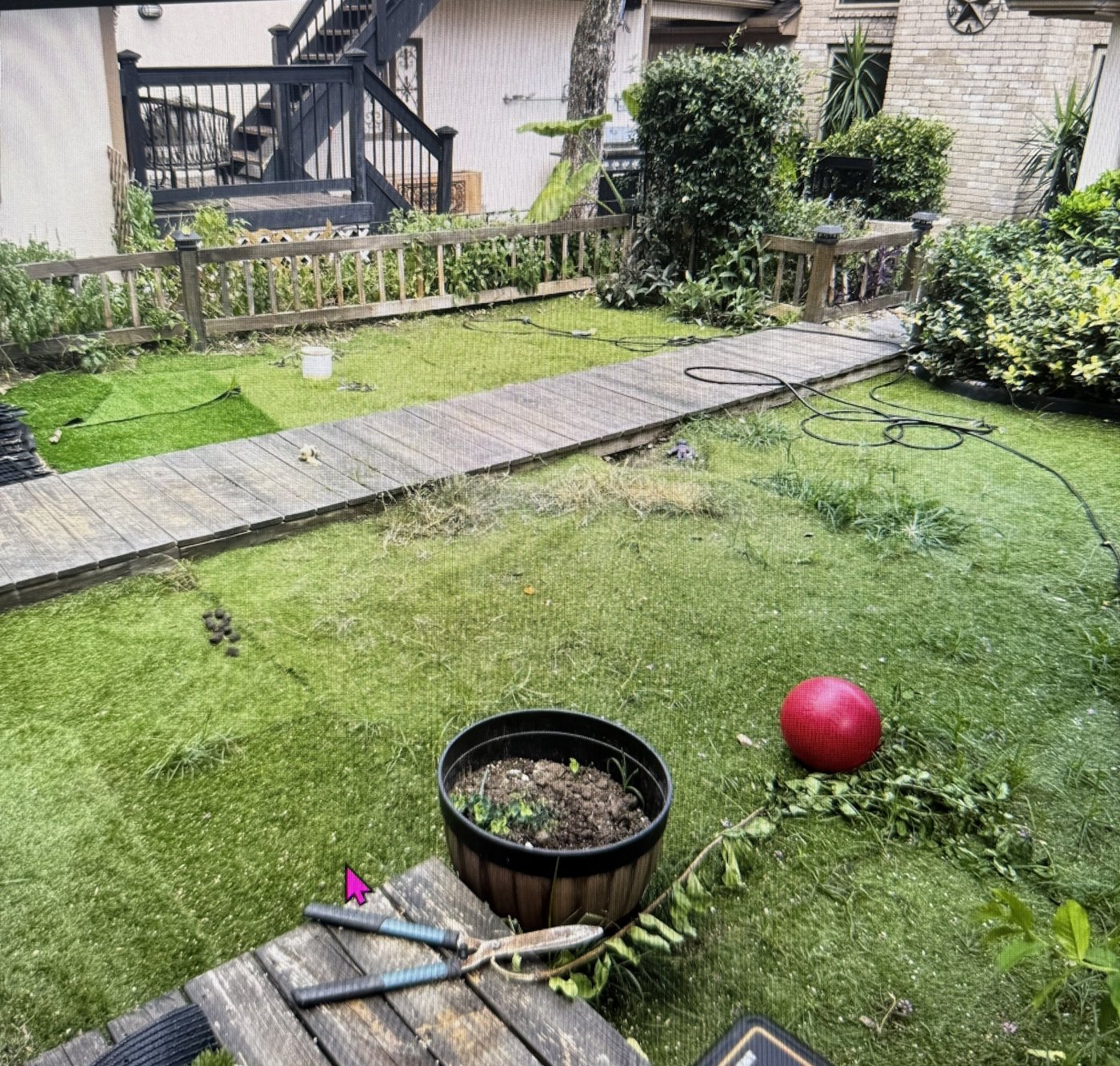 Worn artificial turf with weeds growing through before replacement in Willis, TX