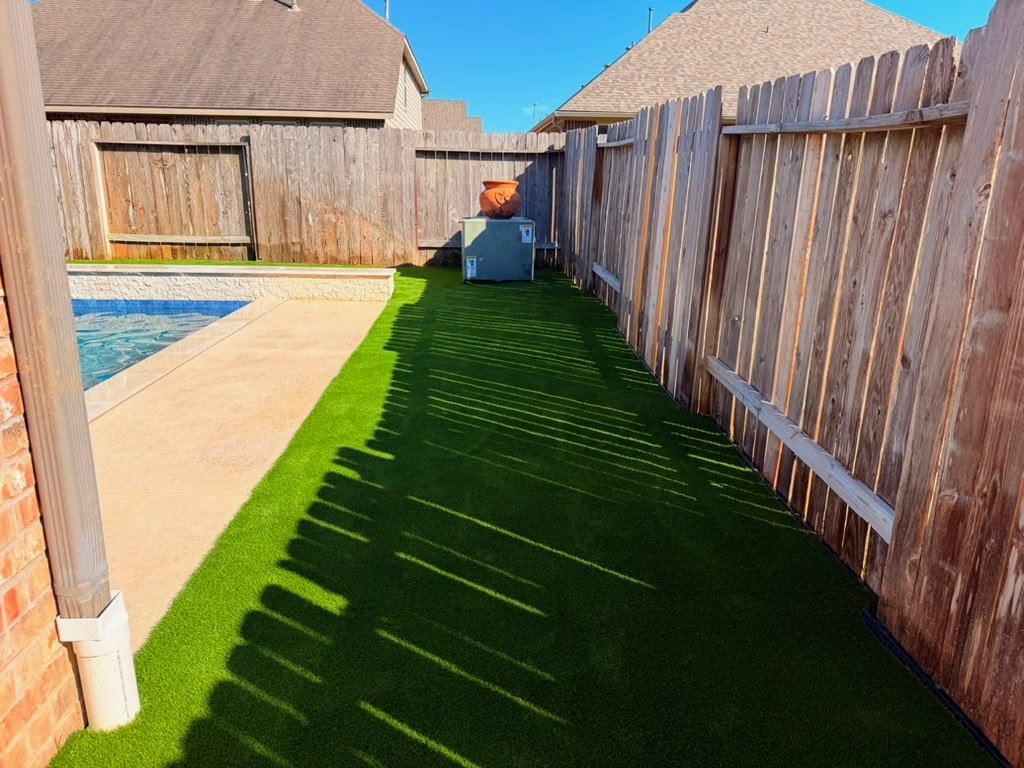 Artificial turf along the fence beside a pool in Tomball, TX